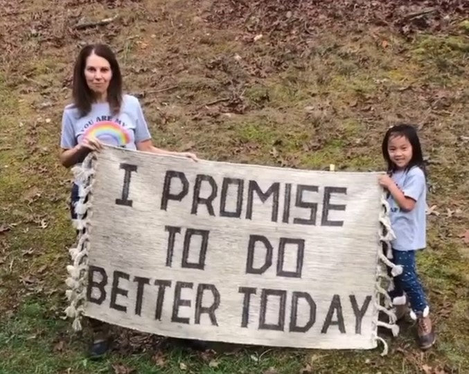 A mother and  heer daughter holding a unique inspirational hand made area rug with braids and saying I promise to do better today