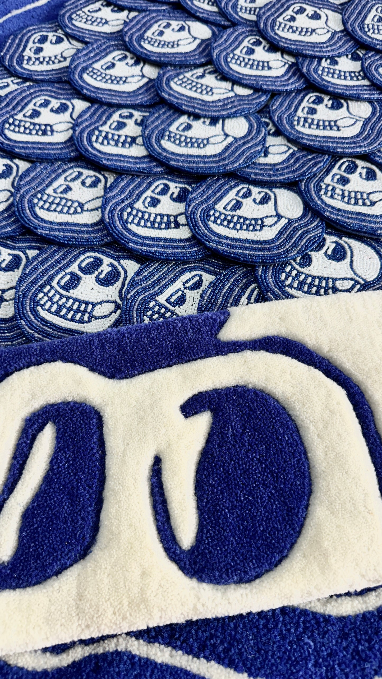 Blue coaters a lot of them hand made in beads with a skull design and a skull shaped keyboard rug in blue and ivory white in pure new zealand wool.