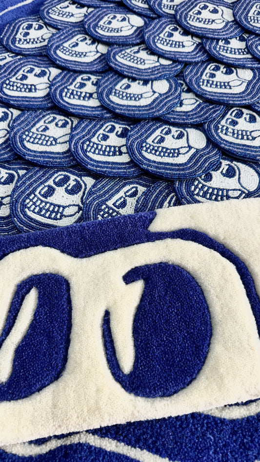 Blue coaters a lot of them hand made in beads with a skull design and a skull shaped keyboard rug in blue and ivory white in pure new zealand wool.