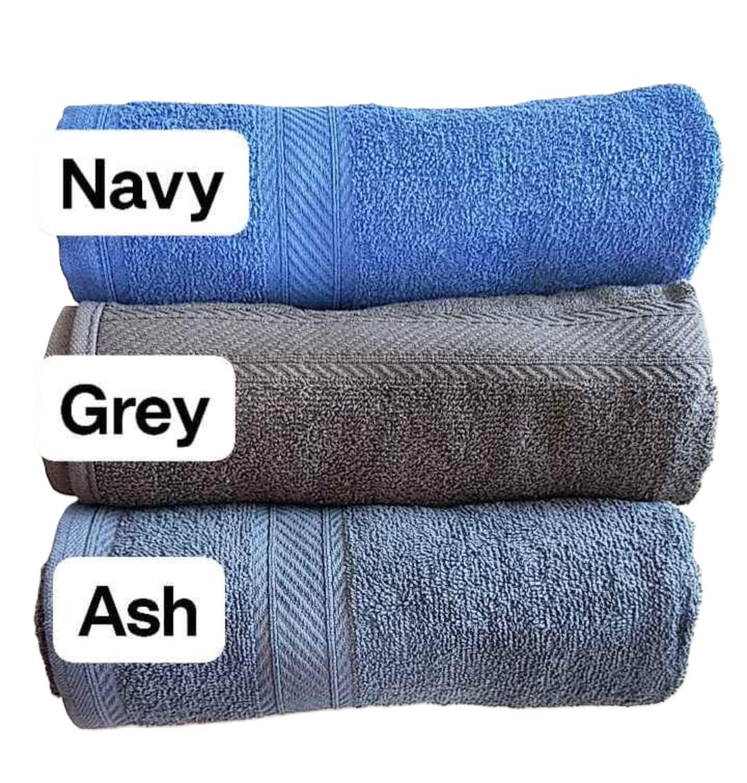 three cotton towels nicely stacked on the top of each other in Navy Gey andAsh color making it look very vibrant and good embriodery
