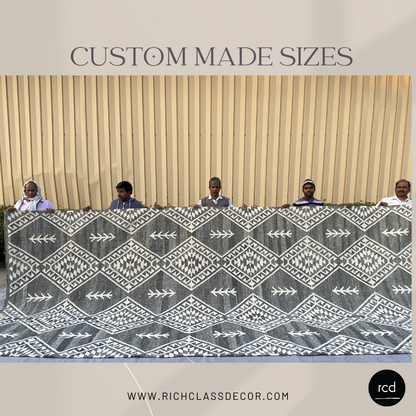 Custom-sized handcrafted kilim rug with intricate geometric patterns, held by skilled artisans. Ethically made using sustainable materials, this bohemian-style rug from Rich Class Decor is perfect for luxury home decor and interior design. Available in bespoke dimensions to suit any space.