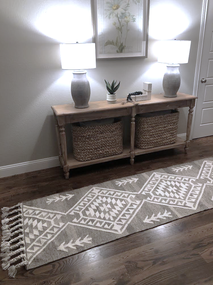 Luxury pure wool hand woven flat weave rug iwth braids in natural grey and ivory a runner n the farmhouse hallway with a beautiful decor