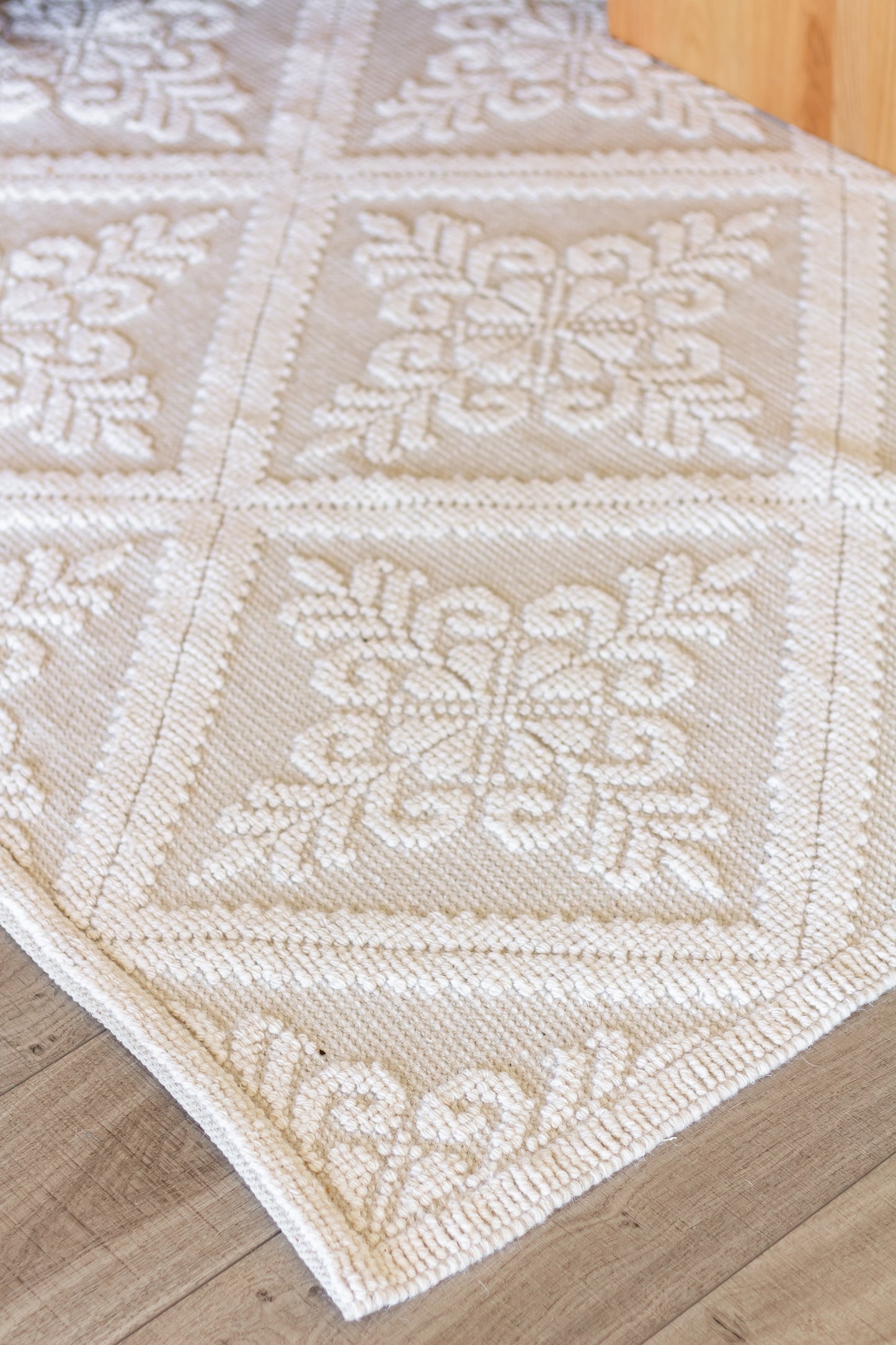 closeup of Handwoven eco-friendly wool rug with diamond pattern in farmhouse style living room