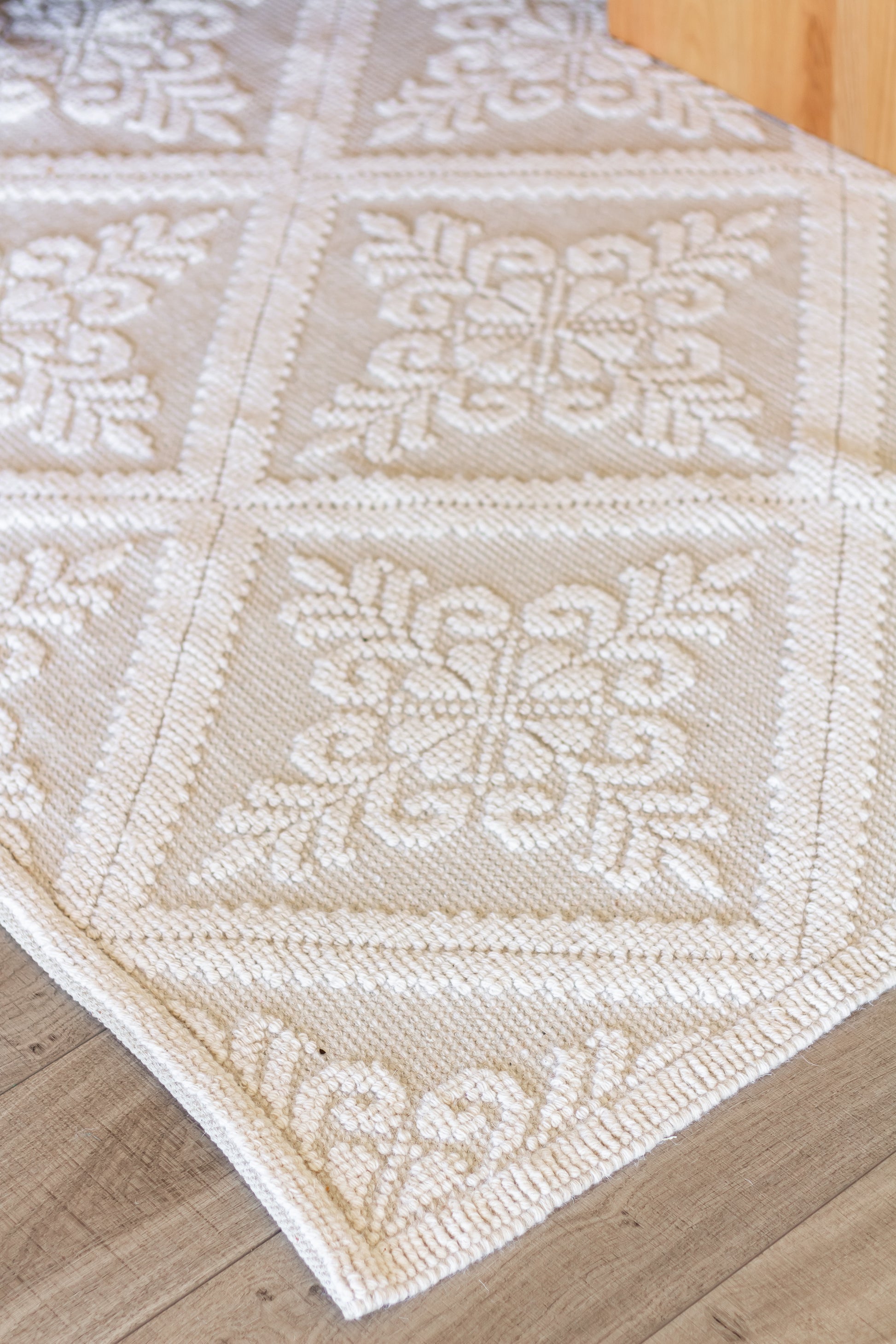 closeup of Handwoven eco-friendly wool rug with diamond pattern in farmhouse style living room