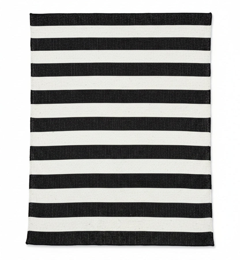 Black and white striped rug on a wooden floor