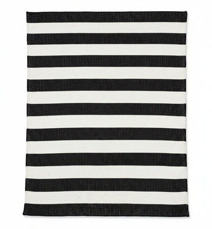 Black and white striped rug on a wooden floor