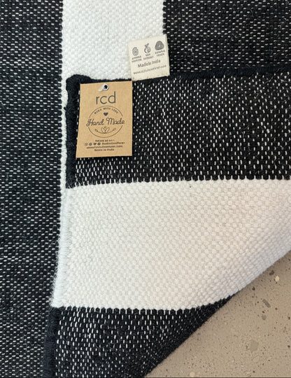 Black and white striped rug on floor