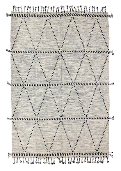 Geometric patterned rug with black and white design on a plain background
