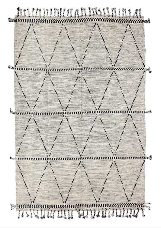 Geometric patterned rug with black and white design on a plain background