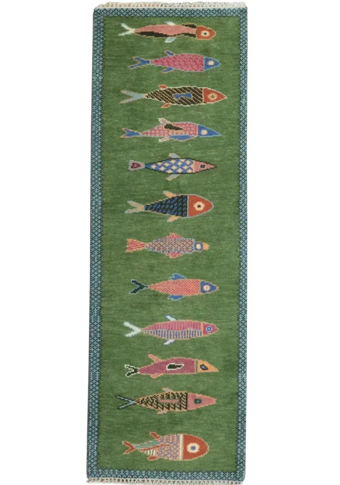 A koi fish green wool rug runner featuring a vertical pattern of stylized fish in pink, blue, red, and black, bordered by a blue patterned edge with white fringe at the top and bottom.