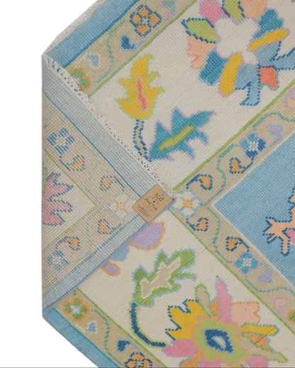 Backing of hand-knotted sky blue Oushak rug showing tight individual knot density and cotton foundation