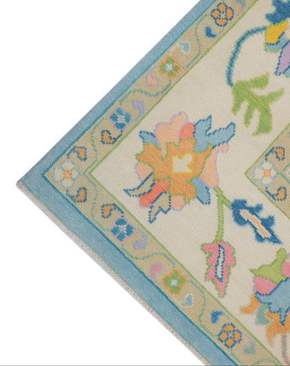 lose-up of hand-knotted Oushak sky blue wool pile showing natural dye colour depth and botanical pattern detail
