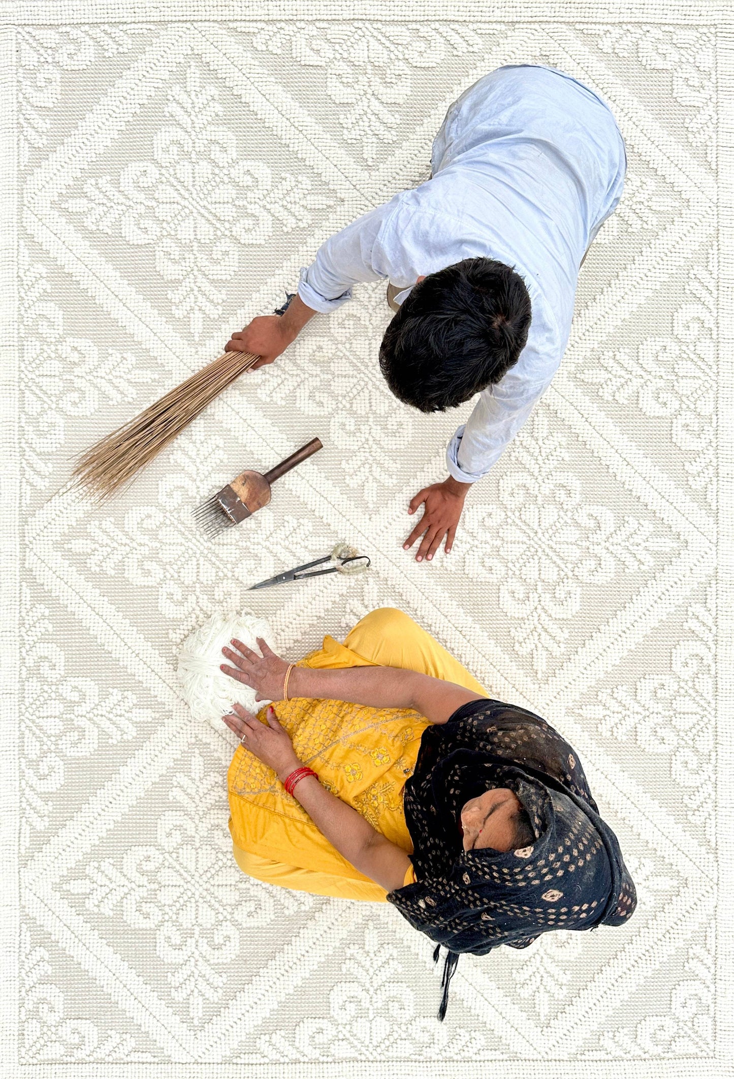 artisans adding finishing touches to our crystal handwoven rug