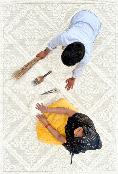 artisans adding finishing touches to our crystal handwoven rug
