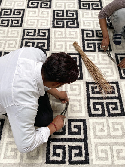 Close up of artisans weaving priscilla rug