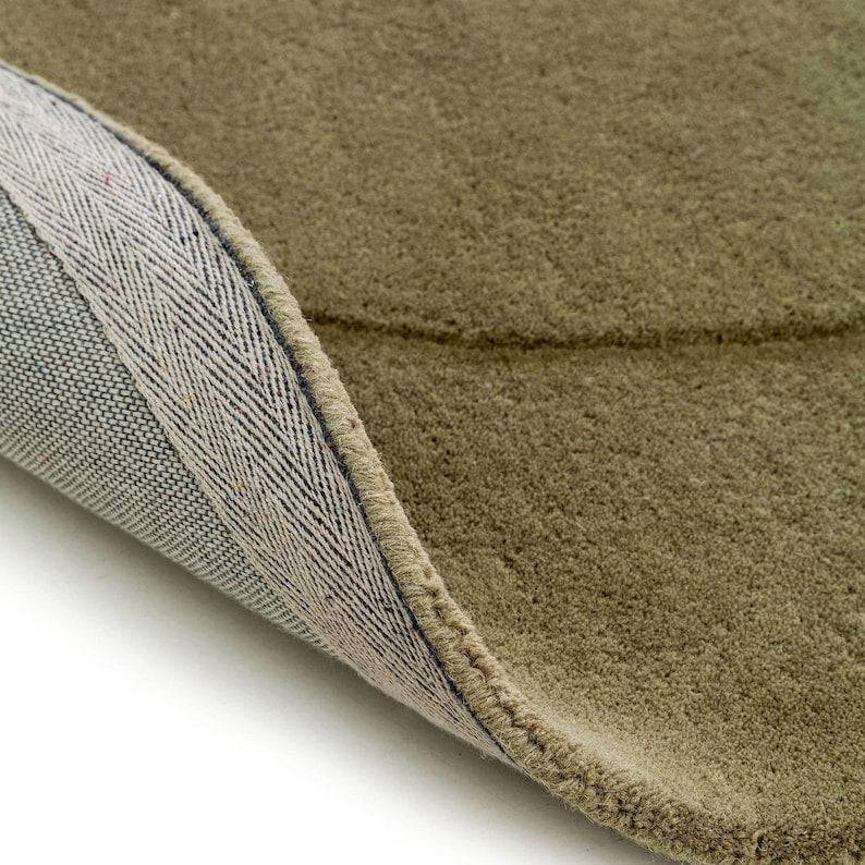 close up of sage green bean shaped rug