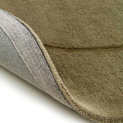 close up of sage green bean shaped rug